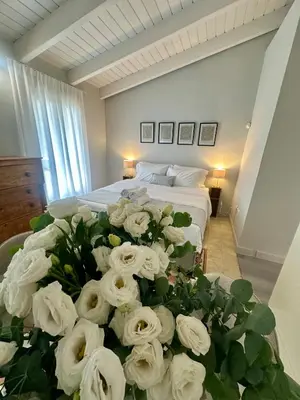 a bedroom with a bed with a bunch of white roses at elan RESIDENCE in Athens