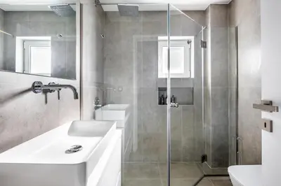 a bathroom with a sink and a shower at Modern Two-Bedroom Haven near Paleo Faliro Beach in Athens