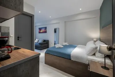 a hotel room with a bed and a couch at Ermou Boutique Studios in Monastiraki in Athens