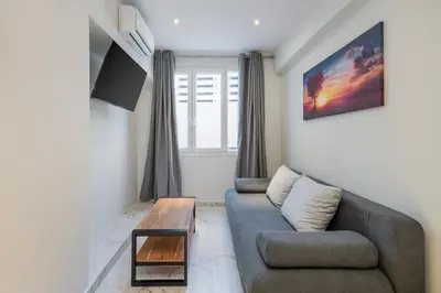 a living room with a couch and a coffee table at Ermou Boutique Studios in Monastiraki in Athens
