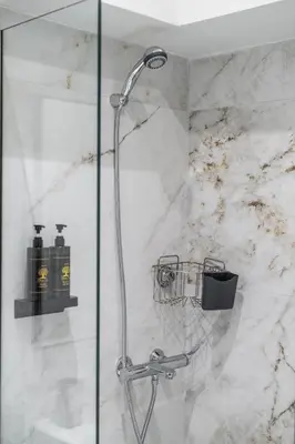 a shower with a shower head in a bathroom at Ermou Boutique Studios in Monastiraki in Athens