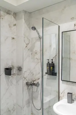 a bathroom with a shower and a sink at Ermou Boutique Studios in Monastiraki in Athens
