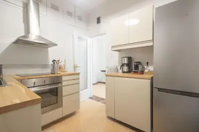 a kitchen with white cabinets and stainless steel appliances at Unbeatable Acropolis Elegant 2-Bedroom Apartment on Areopagitou in Athens