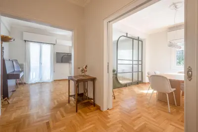 a living room with a table and a desk at Unbeatable Acropolis Elegant 2-Bedroom Apartment on Areopagitou in Athens