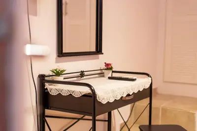 a dressing table in a room with a mirror at Artemis Riviera Near Athen's Airport By SEM in Artemida