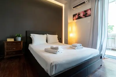 a bedroom with a bed with towels on it at Athens Charm Meets Contemporary Design in Thissio in Athens