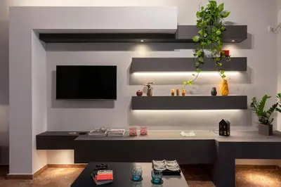 a living room with a couch and a tv on a wall at Athens Charm Meets Contemporary Design in Thissio in Athens