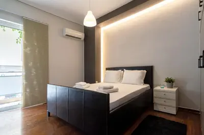 a bedroom with a large bed with white pillows at Athens Charm Meets Contemporary Design in Thissio in Athens