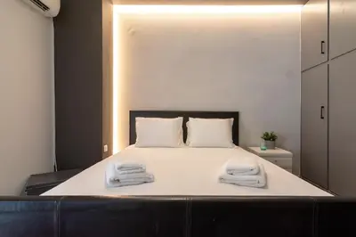 a bedroom with a bed with two towels on it at Athens Charm Meets Contemporary Design in Thissio in Athens