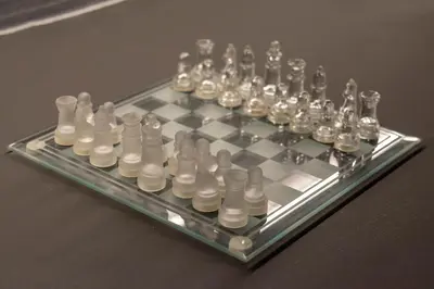 a glass chess board with white chess pieces on it at Athens Charm Meets Contemporary Design in Thissio in Athens