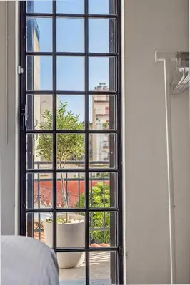 a bedroom with a window with a potted plant at Athens Design Residence in Athens