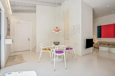 a white living room with a table and chairs at Athens Design Residence in Athens