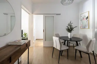 a dining room with a table and chairs at Stylish 1BR Retreat Near Alimos Beach Tram in Athens