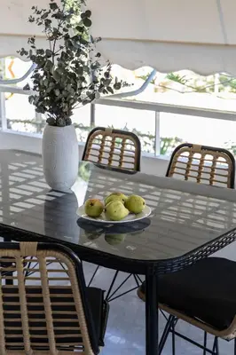 a table with a plate of green apples on it at Stylish 1BR Retreat Near Alimos Beach Tram in Athens