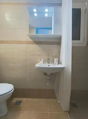 a bathroom with a sink and a toilet at TCG Central Apartment in Athens