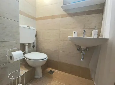 a bathroom with a toilet and a sink at TCG Central Apartment in Athens