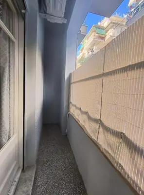 a hallway with a brick wall and a window at TCG Central Apartment in Athens