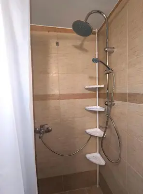 a shower with a shower head in a bathroom at TCG Central Apartment in Athens