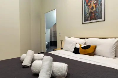 a bedroom with a large bed with white pillows at Nobia 1 in Athens