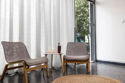 two chairs and a table in a room with a window at Nobia 1 in Athens