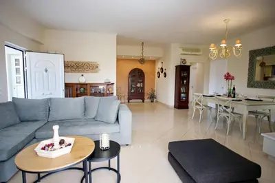 a living room with a couch and a table at Blue Oliva House in Aghia Marina