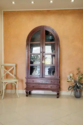 a wooden cabinet with a window in a room at Blue Oliva House in Aghia Marina