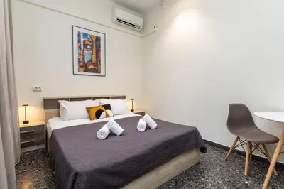 a bedroom with a bed with two pillows on it at Nobia 2 in Athens