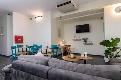 a living room with a couch and tables and chairs at Nobia 2 in Athens