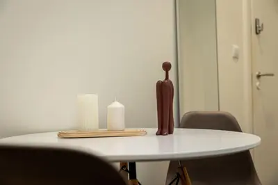 a table with a candle and a candle holder on it at Nobia 2 in Athens