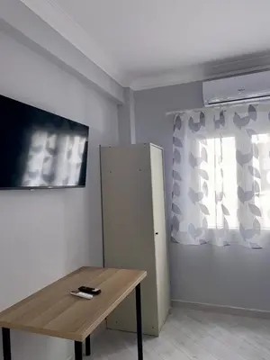 a room with a wooden table and a window at City Core Studio in Athens