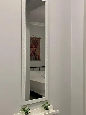 a mirror with a white frame on a wall at City Core Studio in Athens