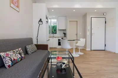 a living room with a couch and a table at Unique Apartment Ideal for Couples in Piraeus