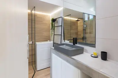 a bathroom with a sink and a mirror at Unique Apartment Ideal for Couples in Piraeus