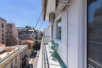 a balcony of a building with a view of a city at Unique Apartment Ideal for Couples in Piraeus