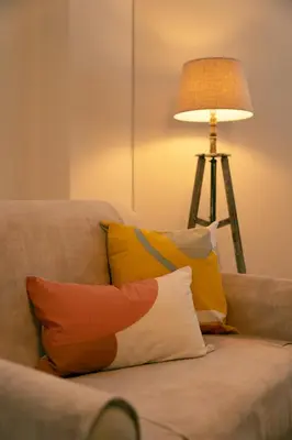 a couch with pillows on it with a lamp at Manolia house near beach in Aghia Marina