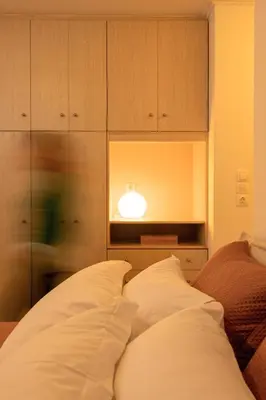 a bedroom with a bed with a light on it at Manolia house near beach in Aghia Marina