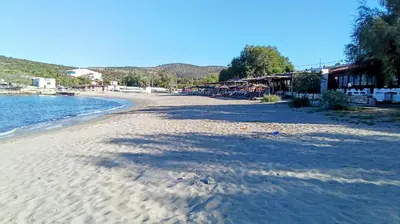 a beach with a lot of sand and water at Manolia house near beach in Aghia Marina