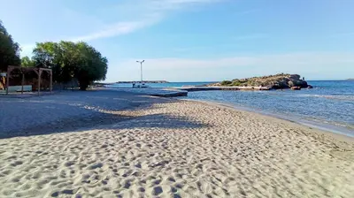 a beach with footprints in the sand and the water at Manolia house near beach in Aghia Marina