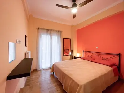 a bedroom with a bed and a ceiling fan at Colmena Arty Athens Apartment in Athens