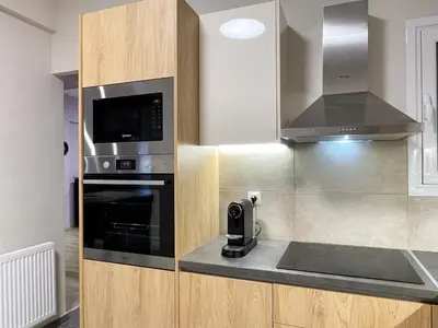 a kitchen with a microwave oven and a stove at Colmena Arty Athens Apartment in Athens