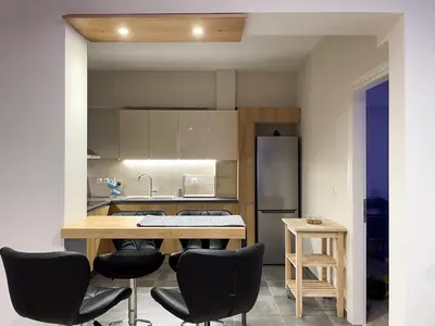 a kitchen with a table and chairs and a refrigerator at Colmena Arty Athens Apartment in Athens