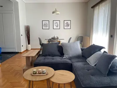 a living room with a blue couch and a table at aθens flat in Athens