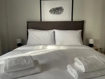 a bedroom with a bed with towels on it at aθens flat in Athens