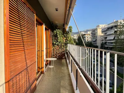 a balcony with a table on the side of a building at aθens flat in Athens