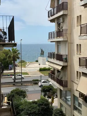 a view of the ocean from a building at MediTerra Stay Athens Riviera Seaview in Athens