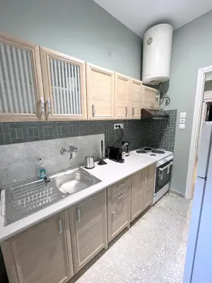 a kitchen with a sink and a stove at MediTerra Stay Athens Riviera Seaview in Athens