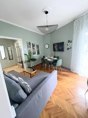 a living room with a couch and a table at MediTerra Stay Athens Riviera Seaview in Athens
