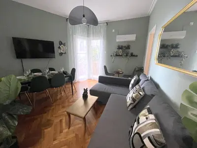a living room with a couch and a table at MediTerra Stay Athens Riviera Seaview in Athens