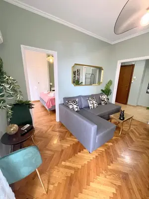 a living room with a couch and a bed at MediTerra Stay Athens Riviera Seaview in Athens