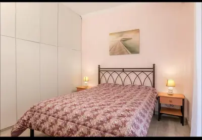 a bedroom with a bed and two lamps on tables at Όνειρα γλυκα in Athens